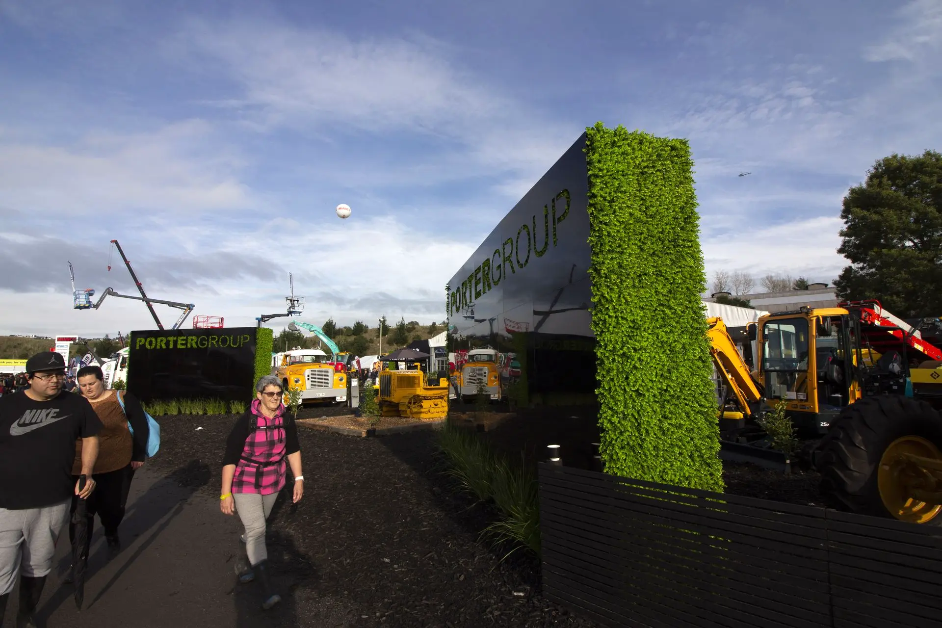 Image shows large scale walls with custom cut lettering and planted edges for a outdoor trade show event.